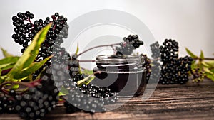 Elderberry tea, elderberry herbal tincture on wood background