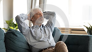 Elderly 60a husband rest on cozy couch at home