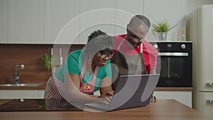 Elderly african couple looking for recipe online