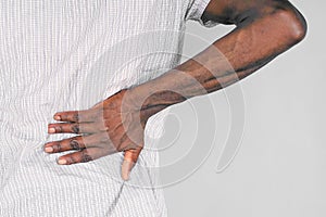 Elderly african man, pain at lower back