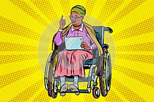 Elderly African woman disabled person in a wheelchair, gadget ta