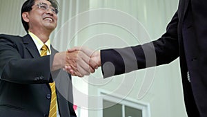 Elderly Asian businessman shake hand, agreed to cooperate business