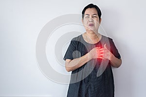 Elderly Asian woman having chest pain suffering from heart attack on white background,Copy space for text