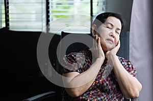 Elderly asian woman sitting near the window at home,Senior having sorrowful and depressed