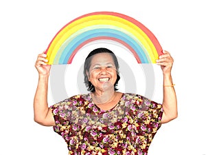 The elderly asian woman smiling while holding colorful rainbow o