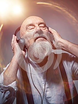 Elderly bald head man with headphones