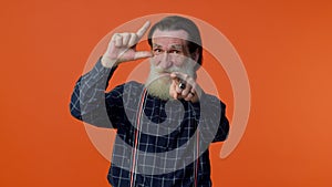 Elderly bearded man showing loser gesture and pointing on you, blaming accusing for unsuccess fail