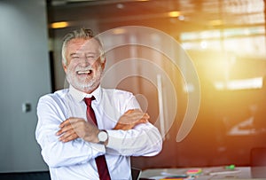 Elderly business man standing confidently smiling and laughing happy in the meeting room
