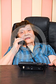 Elderly business woman speaking at telephone