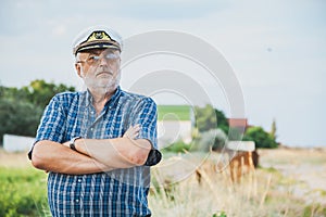 Elderly captain on the sea shore