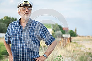 Elderly captain on the sea shore