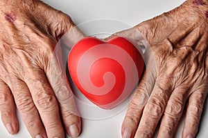 Elderly care concept, Senior people holding red heart to help and support, Family take care and nursing old people health