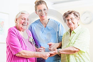 Elderly care nurse with two senior women