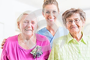 Elderly care nurse with two senior women