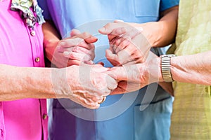 Elderly care nurse with two senior women