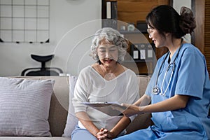 Elderly caregivers are helping to check the health and care for an elderly woman at home.