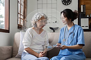 Elderly caregivers are helping to check the health and care for an elderly woman at home.