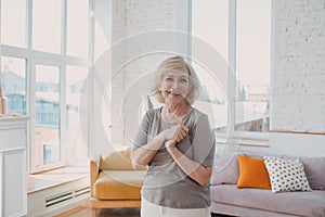 Elderly caucasian old aged woman portrait gray haired positive smiling stand.