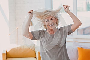 Elderly caucasian old aged woman portrait gray haired touching holds hair.