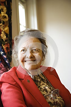 Elderly Caucasian woman by window.