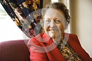 Elderly Caucasian woman by window.
