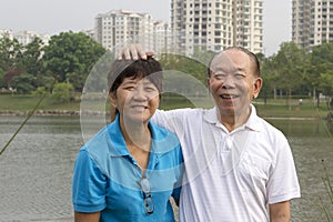 Elderly Chinese couple laughing and playful