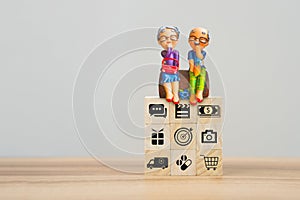 Elderly clay doll on wooden cube block. Retirement Planning Ideas, saving money, retirement and health care.