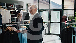 Elderly client looking for formal blazers at shopping mall