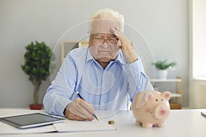 Elderly concentraited tired man thinking about saving pension