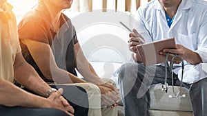 Elderly couple, ageing senior patients having exam and family consultation in clinic with doctor