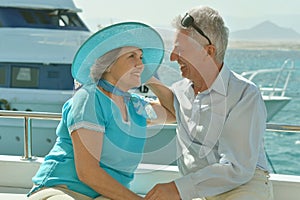 Elderly couple in boat on sea