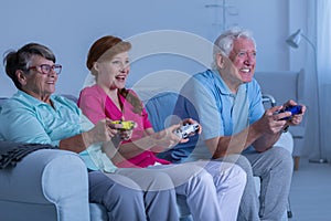 Elderly couple and caregiver playing