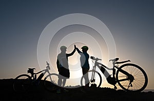 Elderly couple of caucasian old man and woman enjoying riding in a spring sunset in front to the sea. happiness and smiles