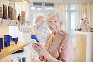 Elderly couple choosing cosmetics in a beauty salon