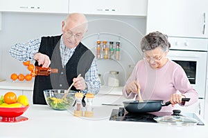 elderly couple cooking indoors