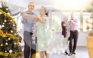 Elderly couple dancing slow dance and enjoying each other at dance salon during celebration Christmas and New Year