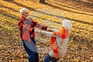 An elderly couple is dancing. Smiling old woman. Movement is life. I feel young again