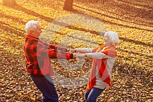 An elderly couple is dancing. Smiling old woman. Movement is life. I feel young again