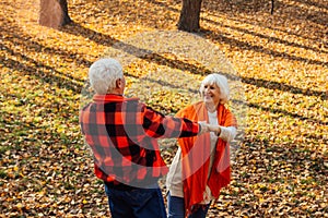 An elderly couple is dancing. Smiling old woman. Movement is life. I feel young again