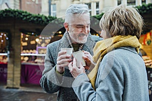 Elderly Couple Drinking Hot Drinks at Christmas Market!