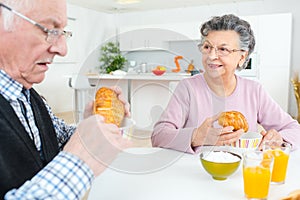 Elderly couple eating Continental breakfast