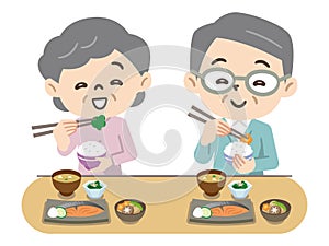 Elderly couple eating with a smile