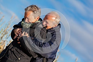 Elderly couple embracing and celebrating the sun