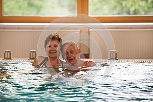 Elderly couple in pool