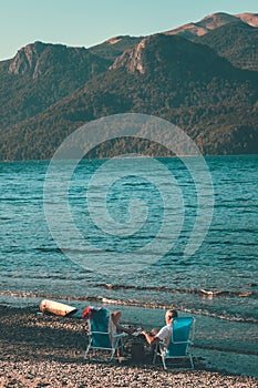 Elderly couple enjoying a peaceful moment together on a sandy beach