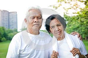 Elderly couple exercising in the garden