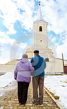 Elderly couple going to the church