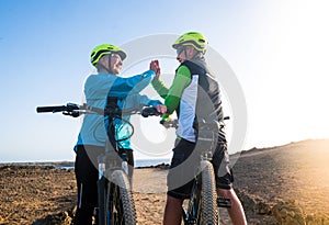 Elderly couple of grandparents enjoy life outdoors with electric bicycle. Healthy lifestyles for old people