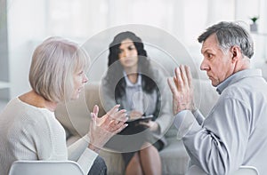 Elderly couple having fight in therapy during session