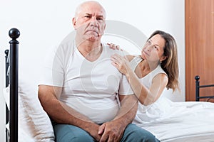 Elderly couple having problems in bedroom.